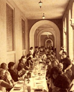 Foto en sepia, gran mesa con estudianes sentados.